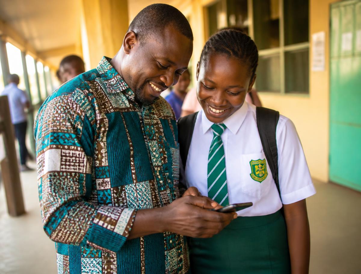 A parent and student checking a published result on a phone